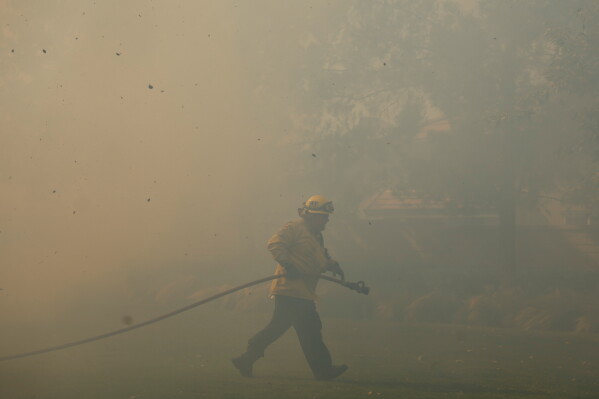 A firefighter works as the Sandy Fire approaches May 19, 2026, in Simi Valley, Calif. (AP Photo/Caroline Brehman, File)