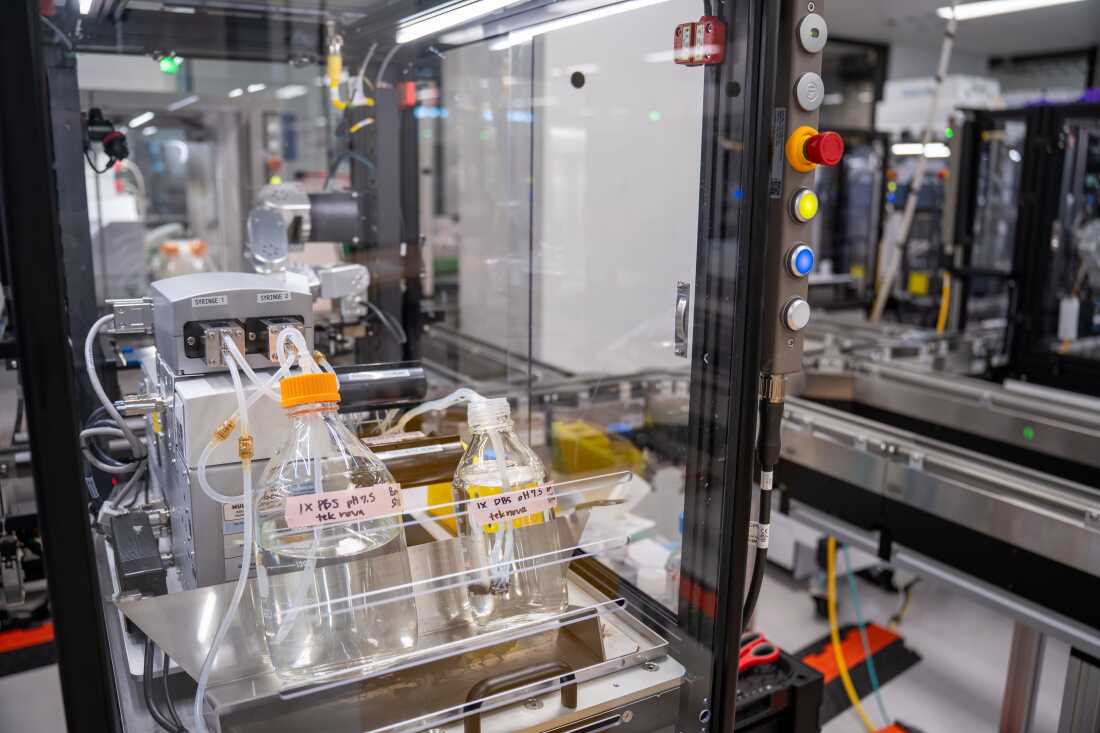 Most of the robots in this lab do not resemble humans, and they perform their work while encased in glass.