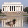 With a blue sky above the Lincoln Memorial, people walk along the reflection pool in Washington, D.C., on June 9, 2023.