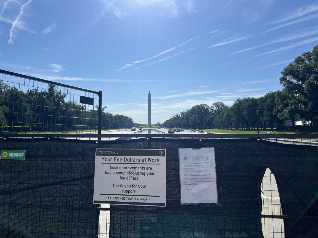 A sign outside the reflecting pool informs visitors that their national park fees helped fund the project.