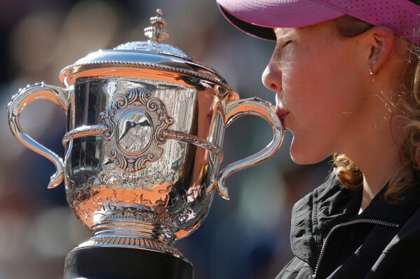 Russia's Mirra Andreeva poses with the trophy after winning the final women's tennis match against Poland's Maja Chwalinska at the French Open in Paris, Saturday, June 6, 2026. (AP Photo/Aurelien Morissard)