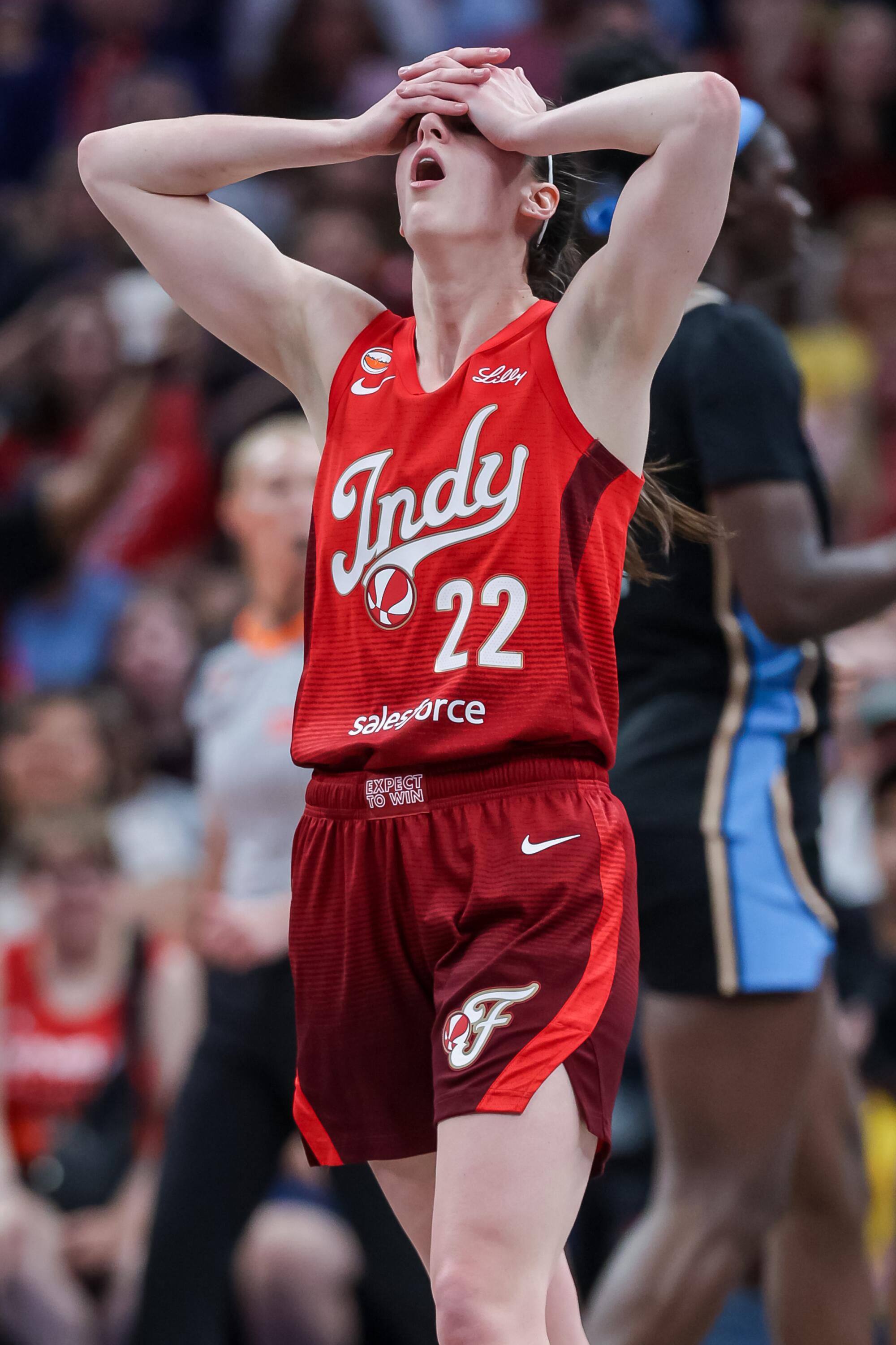 Fever guard Caitlin Clark puts both hands on her head in a moment of disbelief during a game against the Dream.