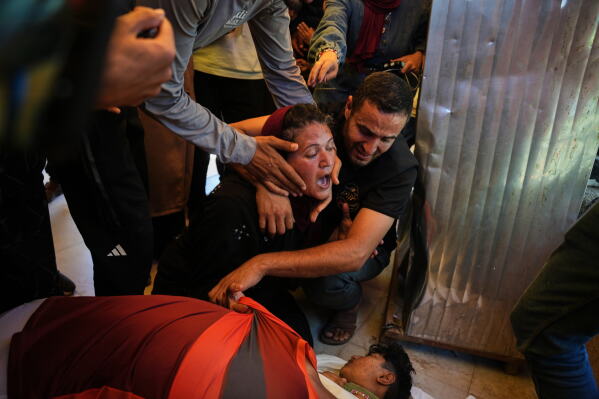 Abeer Abu Younis mourns over the body of her son, Mustafa Abu Younis, 14, who was killed in an Israeli airstrike in Khan Younis, southern Gaza Strip, Sunday, June 7, 2026. (AP Photo/Abdel Kareem Hana)