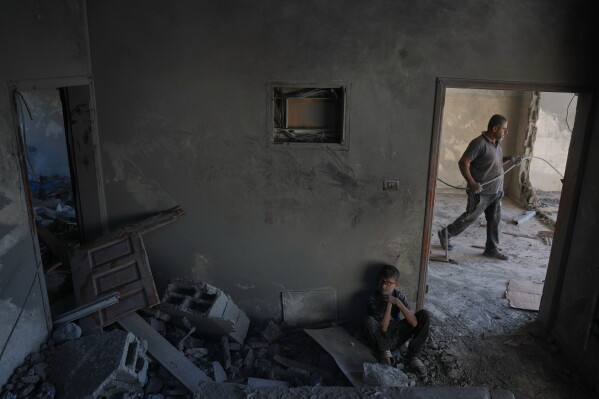 Mohammed Saidam, 14, sits in a room of a heavily damaged apartment following an Israeli strike in Zawaida, in the central Gaza Strip, Friday, June 5, 2026. (AP Photo/Abdel Kareem Hana)