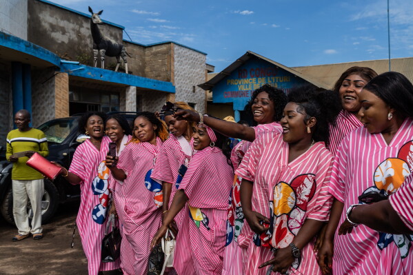 Wedding guests cheer at a wedding ceremony amid an Ebola outbreak in Ituri Province in Bunia, Congo, Saturday, June 6, 2026. 2026. (AP Photo/Moses Sawasawa)