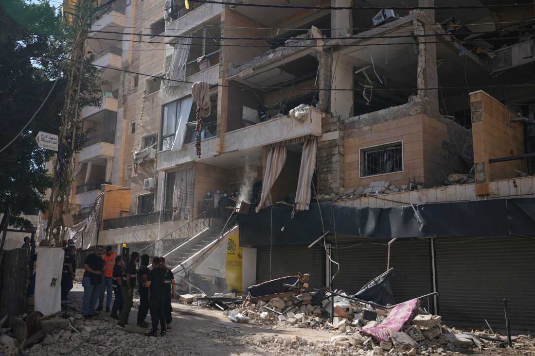 Lebanese security officers gather at the site where an Israeli airstrike hit a building in Dahiyeh, Beirut's southern suburb, Lebanon, Sunday, June 7, 2026.