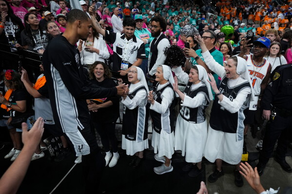 The Salesian Sisters greet players prior to Game 1 of the NBA Finals basketball series between the New York Knicks and the San Antonio Spurs, Wednesday, June 3, 2026, in San Antonio. (AP Photo/Eric Gay)