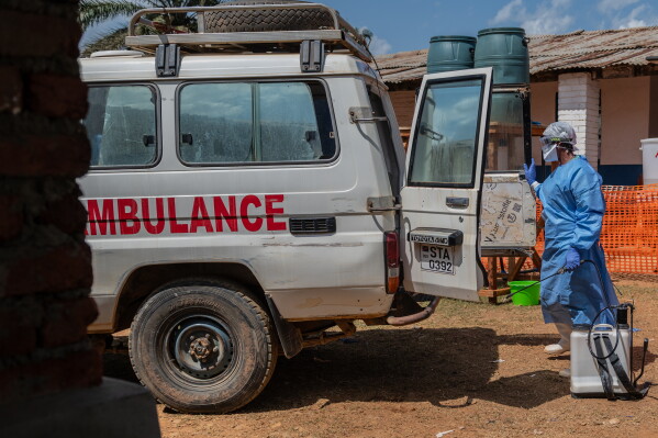 A health worker disinfects an ambulance at the Mongbwalu treatment center that transported a suspected Ebola patient in Mongbwalu, Congo, Friday, June 5, 2026. (AP Photo/Moses Sawasawa)
