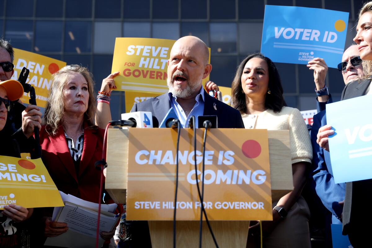 California Republican gubernatorial candidate Steve Hilton, center, flanked by others hold a press conference