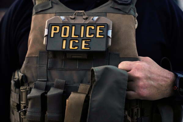 A U.S. Immigration and Customs Enforcement agent is seen in Park Ridge, Ill., Sept. 19, 2025. (AP Photo/Erin Hooley, File)