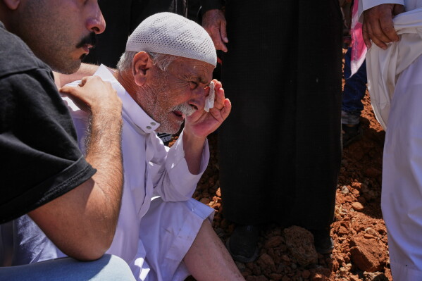 Arsan Qutaish al-Hariri cries during the funeral of his daughter and three grandchildren, killed in Israeli strikes in southern Lebanon, in Busra al-Harir, in Syria's southern Daraa province, Wednesday, June 10, 2026. (AP Photo/Omar Albam)