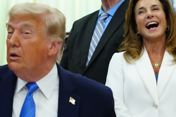 Rep. Lisa McClain, R-Mich., chair of the House Republican Conference, laughs as President Donald Trump speaks in the Oval Office of the White House, Wednesday, June 10, 2026, in Washington. (AP Photo/Julia Demaree Nikhinson)