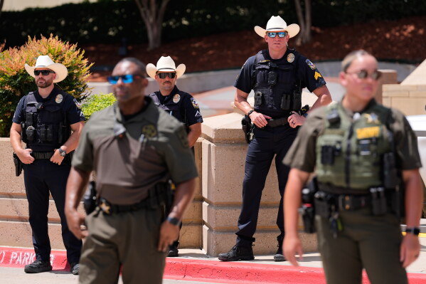 Law enforcement officials stand in front of the Collin County courthouse at the verdict was reached in the Karemlo Anthony trial Tuesday, June 9, 2026, in McKinney, Texas. (AP Photo/Tony Gutierrez)