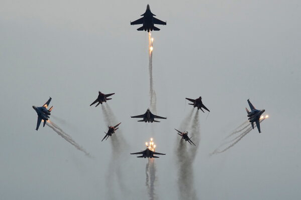Sukhoi Su-30SM and Su-35S jet fighters of the Russian Knights aerobatic team perform during the International Maritime Defence Show 'Fleet-2026' in Kronstadt, outside St. Petersburg, Russia, Wednesday, June 10, 2026. (AP Photo/Dmitri Lovetsky)