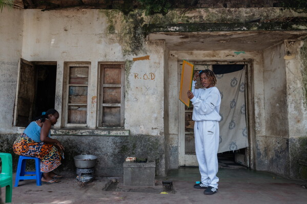 Wedy's Perle Sarah, a musician, prepares to go to the studio to record an Ebola-awareness song in Bunia, Congo, Tuesday, June 9, 2026. (AP Photo/Moses Sawasawa)