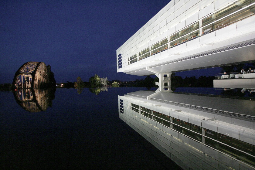 Lights reflect off a railroad bridge on the grounds of Bill Clinton's presidential library as the lighted center is reflected in a fountain in Little, Rock, Ark.