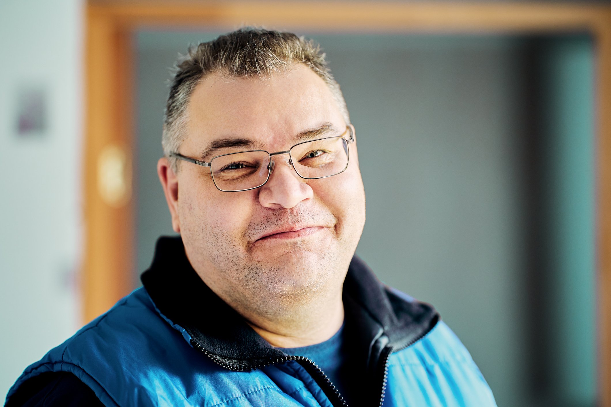 Smiling person in blue jacket.