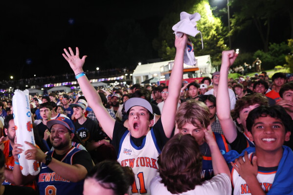 New York Knicks fans react during a watch party inside Central Park for Game 4 of the NBA Finals basketball series between the Knicks and the San Antonio Spurs, Wednesday, June 10, 2026, in New York. (AP Photo/Heather Khalifa)
