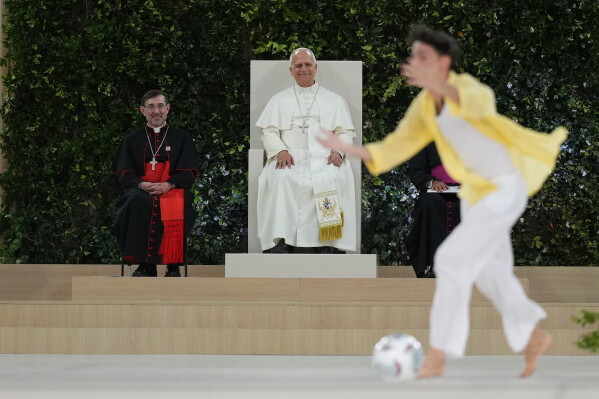 Youths stage a soccer match during a meeting with Pope Leo XIV and the diocesan community at the Santiago Bernabeu stadium in Madrid, Spain, Monday, June 8, 2026 (AP Photo/Alessandra Tarantino)