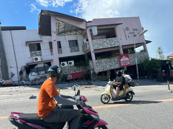 Residents pass by a collapsed structure after an earthquake in General Santos, Philippines on Monday, June 8, 2026. (AP Photo)