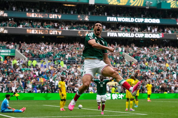 Mexico's Raul Jimenez celebrates after scoring his side's second goal during the World Cup Group A soccer match between Mexico and South Africa in Mexico City, Thursday, June 11, 2026. (AP Photo/Natacha Pisarenko)