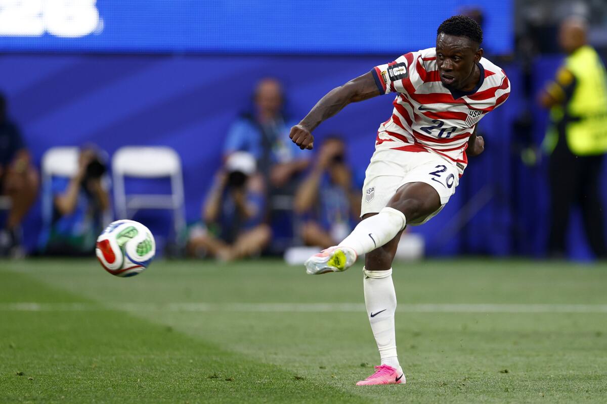 U.S. striker Folarin Balogun scores in the first half.