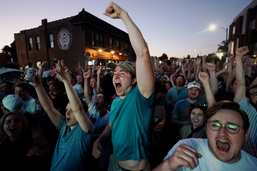 United States fans celebrate a goal as the team routs Paraguay, 4-1, during the FIFA World Cup on Friday, June 12, 2026, outside of Amsterdam Tavern in south St. Louis.