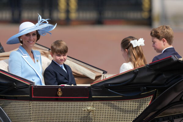 Kate Princess of Wales, left with her children Prince Louis, Princess Charlotte and Prince George ride in an open top carriage during Trooping The Colour, the King's annual birthday parade, in London, Saturday, June 13, 2026. (AP Photo/Kirsty Wigglesworth)