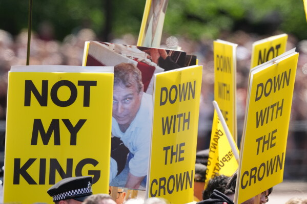 Republican 'Not My King' protesters demonstrate during Trooping The Colour, the King's annual birthday parade, in London, Saturday, June 13, 2026. (AP Photo/Kirsty Wigglesworth)