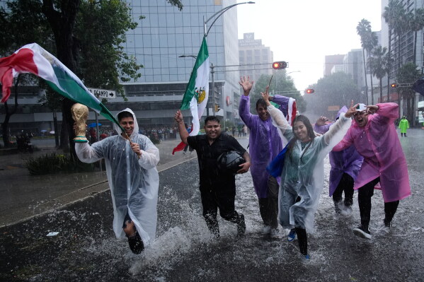 Fans celebrate after Mexico defeated South Africa in the opening match of the soccer World Cup in Mexico City, Thursday, June 11, 2026. (AP Photo/Marco Ugarte)
