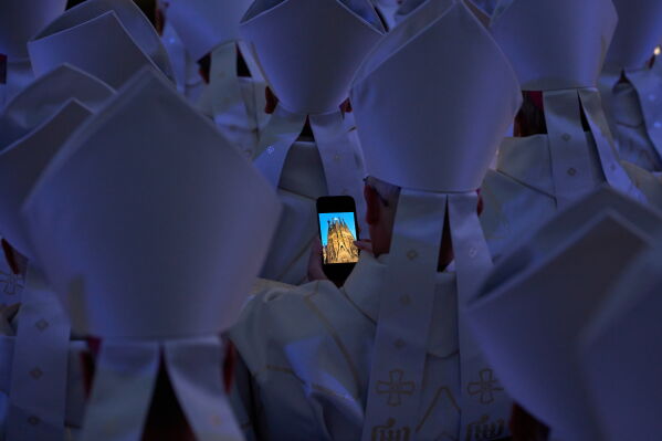 Clergy gather around Antoni Gaudí's Basilica of the Sagrada Família as Pope Leo XIV blesses the newly completed central Tower of Jesus Christ in Barcelona, Spain, Wednesday, June 10, 2026. CORRECTS FROM PRIESTS TO CLERGY (AP Photo/Emilio Morenatti)