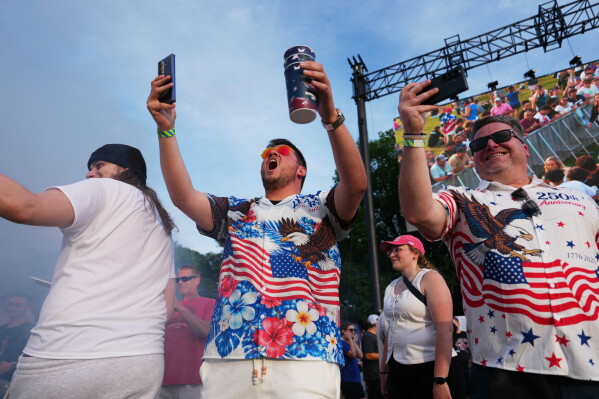UFC fans take video before the ceremonial UFC Freedom 250 weigh-ins on the Ellipse, Saturday, June 13, 2026, in Washington, ahead of Sunday's fight on the South Lawn of the White House. (AP Photo/Julia Demaree Nikhinson)