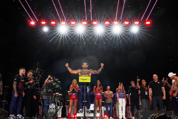 Ilia Topuria, center, during the ceremonial UFC Freedom 250 weigh-ins on the Ellipse, Saturday, June 13, 2026, in Washington, ahead of Sunday's fight on the South Lawn of the White House. (AP Photo/Julia Demaree Nikhinson)