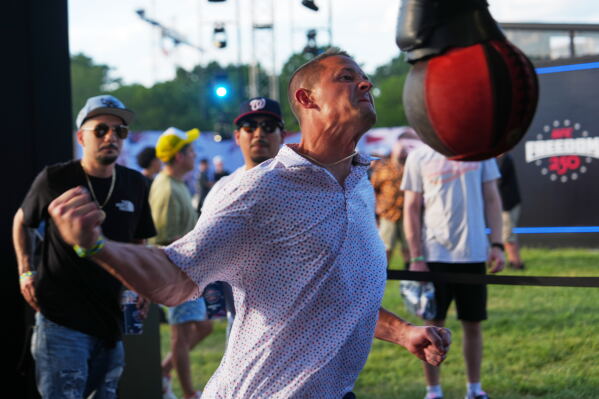 A UFC fan participates in the UFC striking challenge before the ceremonial UFC Freedom 250 weigh-ins on the Ellipse, Saturday, June 13, 2026, in Washington, ahead of Sunday's fight on the South Lawn of the White House. (AP Photo/Julia Demaree Nikhinson)