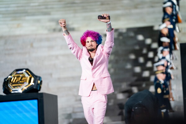 UFC bantamweight fighter Sean O'Malley enters a UFC news conference at the Lincoln Memorial, ahead of Sunday's fight on the South Lawn of the White House, Friday, June 12, 2026, in Washington. (AP Photo/Allison Robbert)