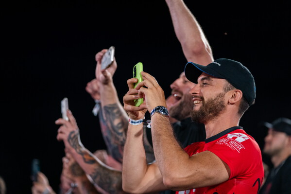 Audience members cheer during a UFC news conference at the Lincoln Memorial, ahead of Sunday's fight on the South Lawn of the White House, Friday, June 12, 2026, in Washington. (AP Photo/Allison Robbert)