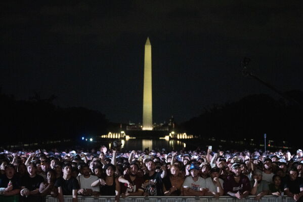 Audience members cheer and boo during a UFC news conference at the Lincoln Memorial, ahead of Sunday's fight on the South Lawn of the White House, Friday, June 12, 2026, in Washington. (AP Photo/Allison Robbert)