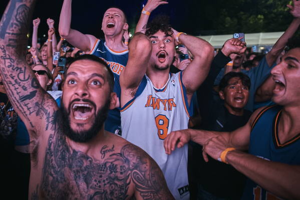 New York Knicks fans celebrate their victory as the watch Game 5 of the NBA Finals basketball series against the San Antonio Spurs, Saturday, June 13, 2026, in New York. (AP Photo/Andres Kudacki)