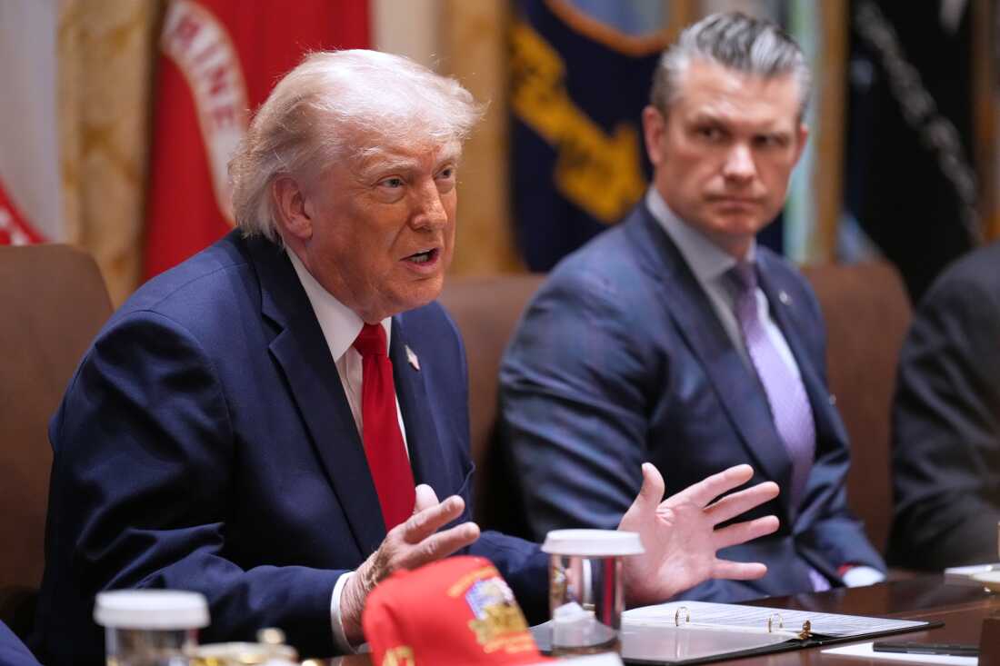 President Donald Trump speaks during a Cabinet meeting at the White House, Wednesday, May 27, 2026, in Washington, as Secretary of Defense Pete Hegseth, looks on.