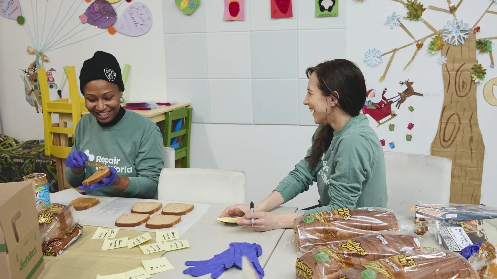 Repair the World volunteers prepare sandwiches