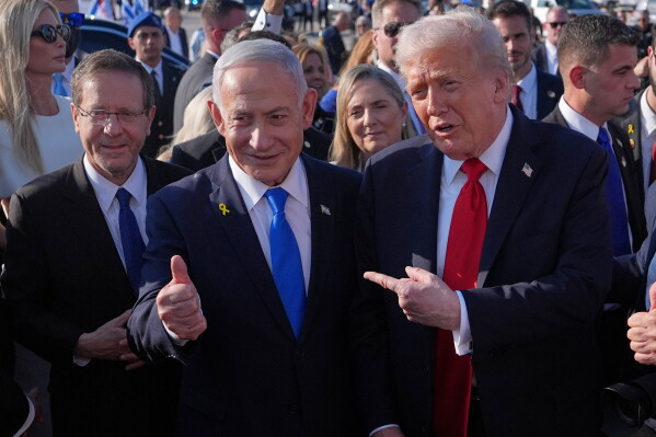 President Donald Trump poses for a photo with Israel's Prime Minister Benjamin Netanyahu before he boards Air Force One at Ben Gurion International Airport, Oct. 13, 2025, near Tel Aviv, as Israel's President Isaac Herzog watches at left. (AP Photo/Evan Vucci, File)