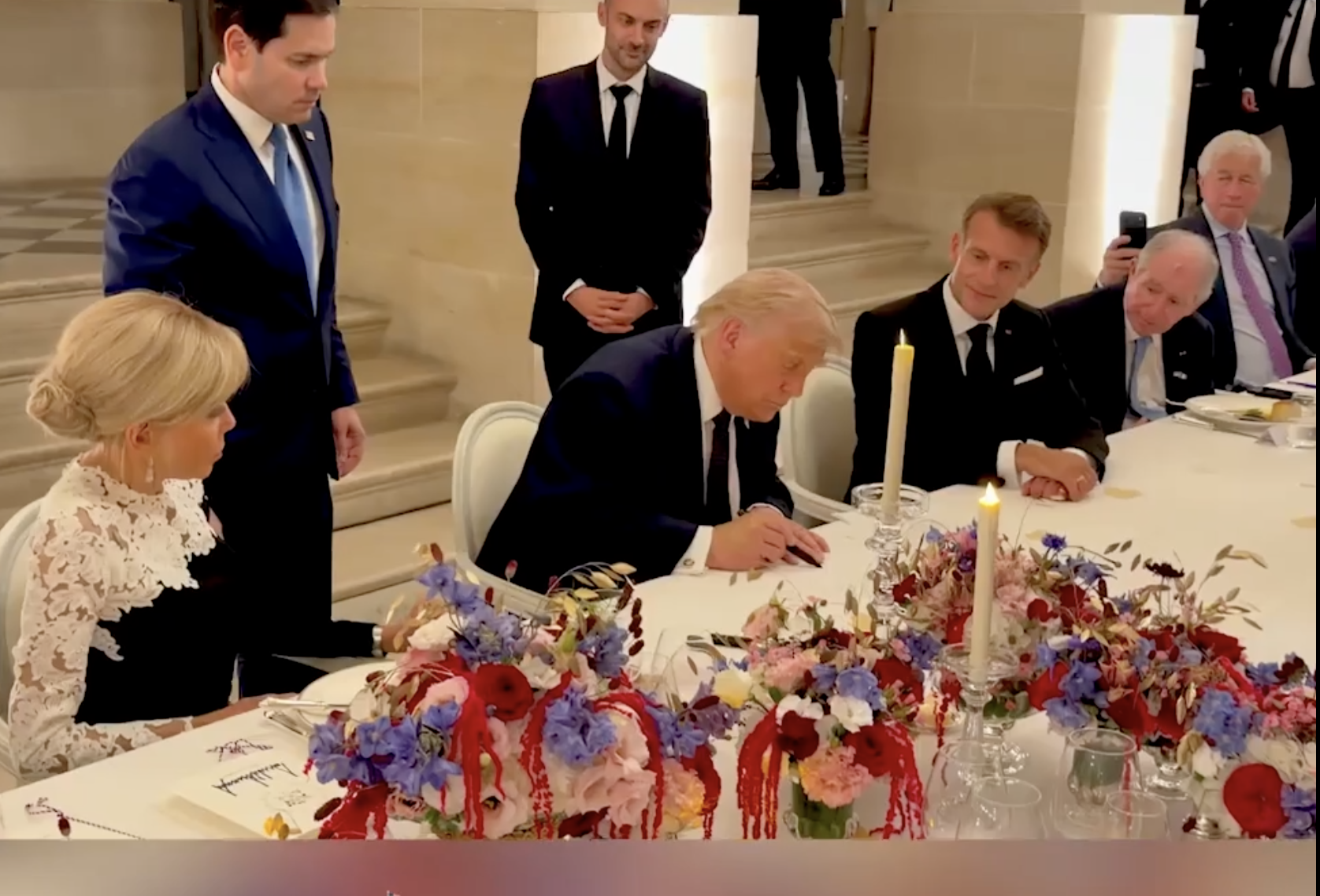 File photo President Trump signs the Iran MOU on Wednesday in France- image from White House video