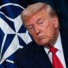 President Donald Trump in front of NATO flag.