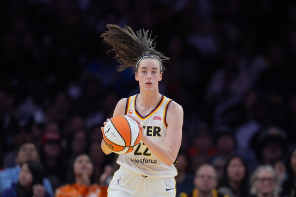 Indiana Fever guard Caitlin Clark (22) dribbles during the first half of a WNBA basketball game against the Los Angeles Sparks Wednesday, May 13, 2026, in Los Angeles. (AP Photo/Jae C. Hong)