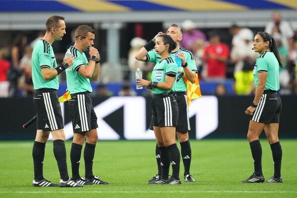 Referees takes a hydration break during the World Cup Group L soccer match between England and Croatia in Arlington, Texas, near Dallas, Wednesday, June 17, 2026. (AP Photo/Julio Cortez)