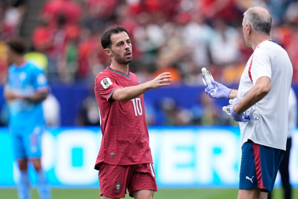 Portugal's Bernardo Silva takes a bottle of water during a hydration break during the World Cup Group K soccer match between Portugal and Congo in Houston, Wednesday, June 17, 2026. (AP Photo/Ashley Landis)
