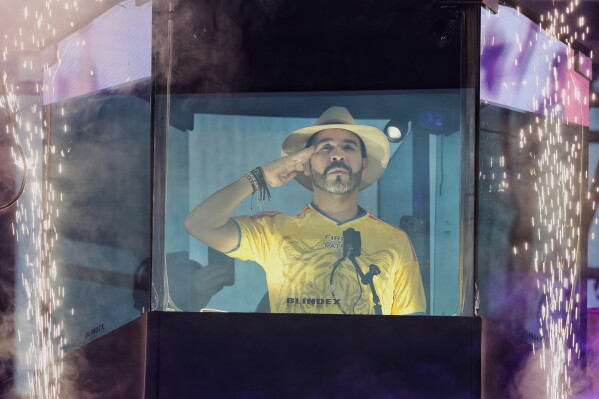 Presidential candidate Abelardo de la Espriella stands before supporters from inside a bulletproof booth during his campaign rally in Buga, Colombia, Sunday, June 14, 2026. (AP Photo/Santiago Saldarriaga)