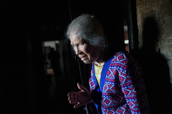 Galyna Danilova, 84, reacts while looking at a burned apartment of a residential house damaged after a Russian strike on Kyiv, Ukraine, on Monday, June 15, 2026. (AP Photo/Evgeniy Maloletka)