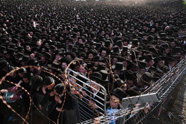 Ultra-Orthodox Jewish men protest against military recruitment and call for the release of detained draft resisters outside a military prison near Kfar Yona, Israel, Wednesday, June 17, 2026. (AP Photo/Ariel Schalit)