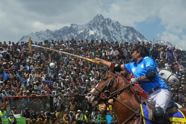 A player reaches for the ball during the final polo match in the three-day annual Shandur Polo Festival in Shandur Pass, in the Ghizer district of Gilgit-Baltistan, northern Pakistan, Saturday, June 13, 2026. (AP Photo/Zubair Abbasi)